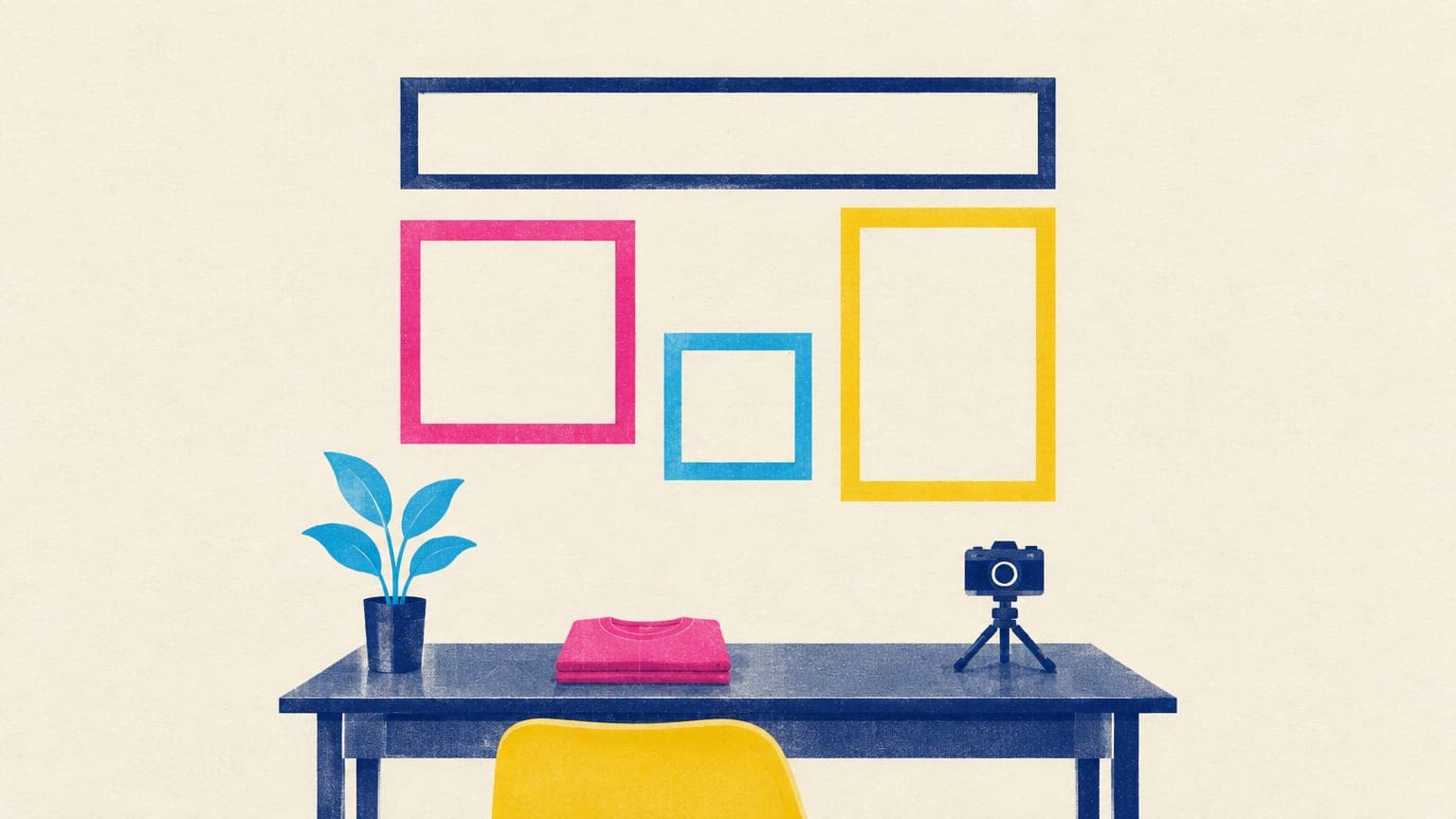 Empty picture frames of different shapes on a wall above a desk with a folded t-shirt and a small camera