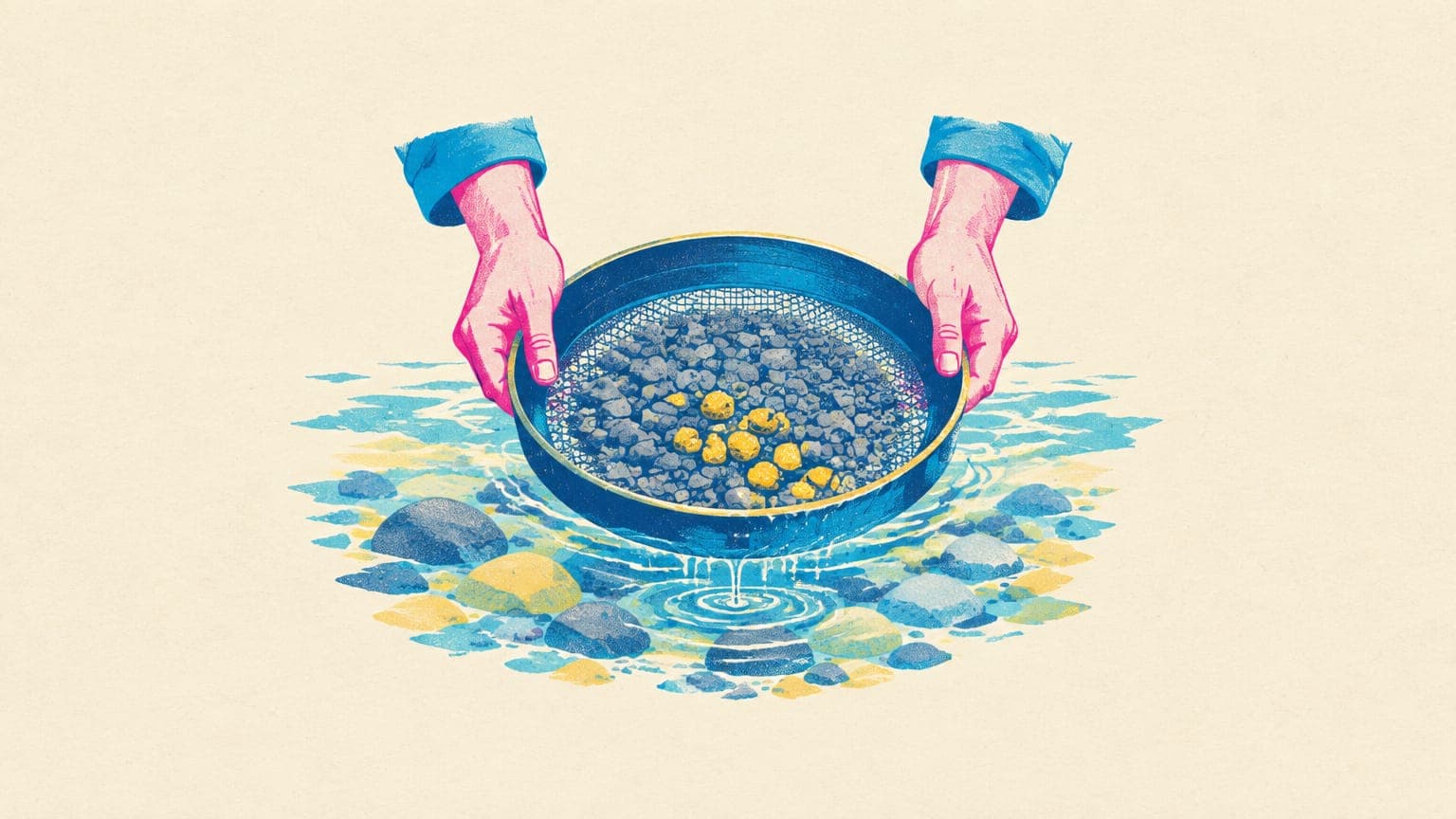 Hands holding a gold-panning sieve that catches a few bright nuggets among gray pebbles
