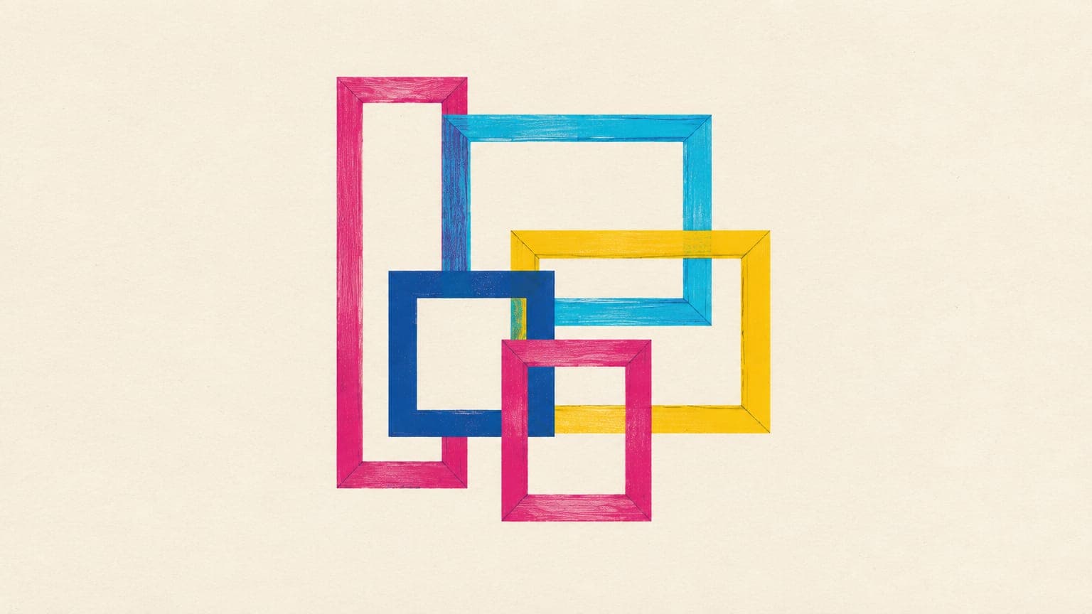 Empty picture frames of different proportions overlapping on a plain wall