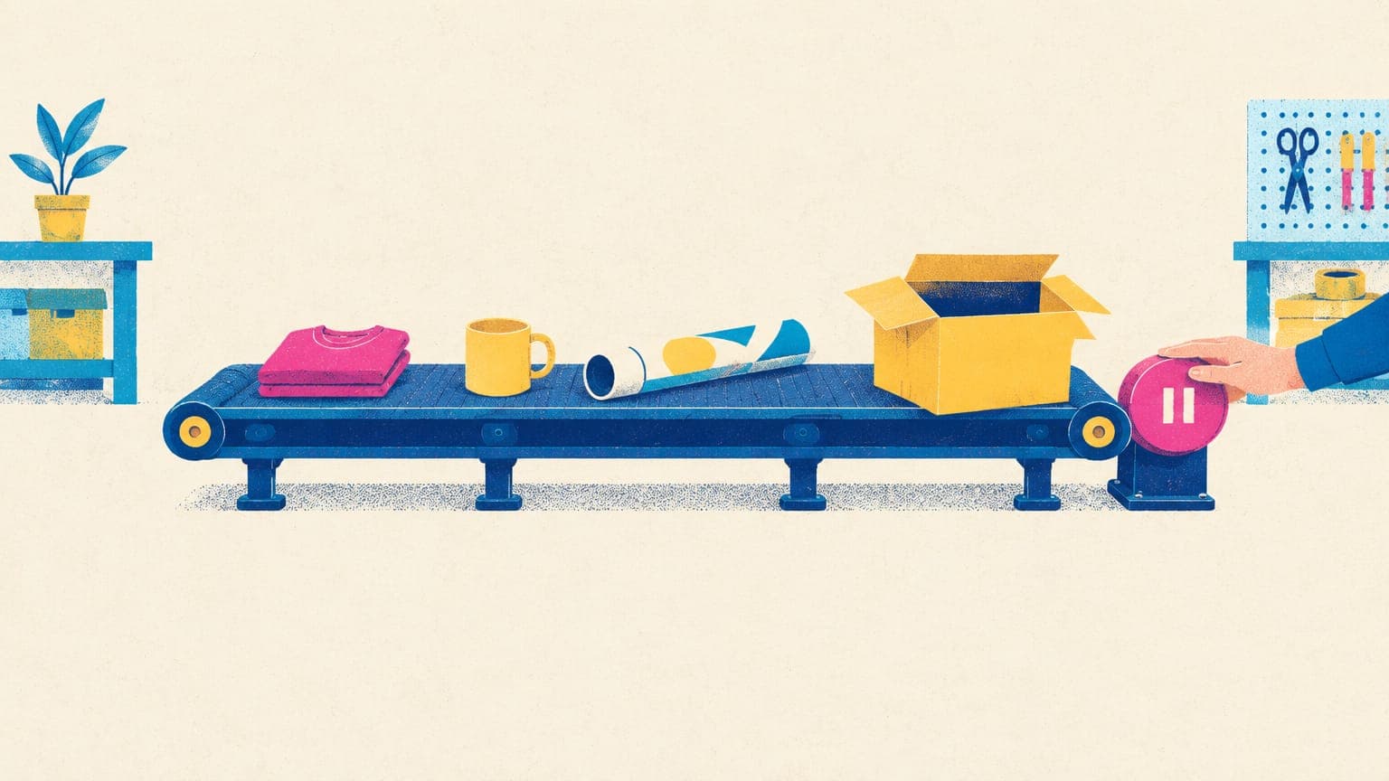 Tabletop conveyor carrying a t-shirt, mug and rolled poster toward a box, with a hand on a pause lever