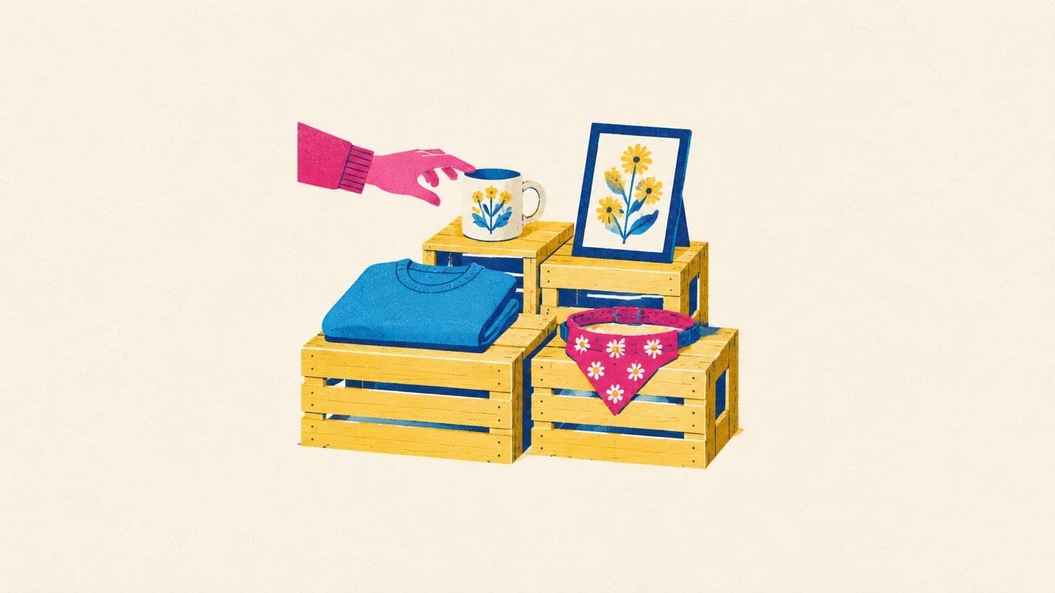 Wooden crate market stall with a sweatshirt, mug, framed print and pet bandana, a hand reaching for one